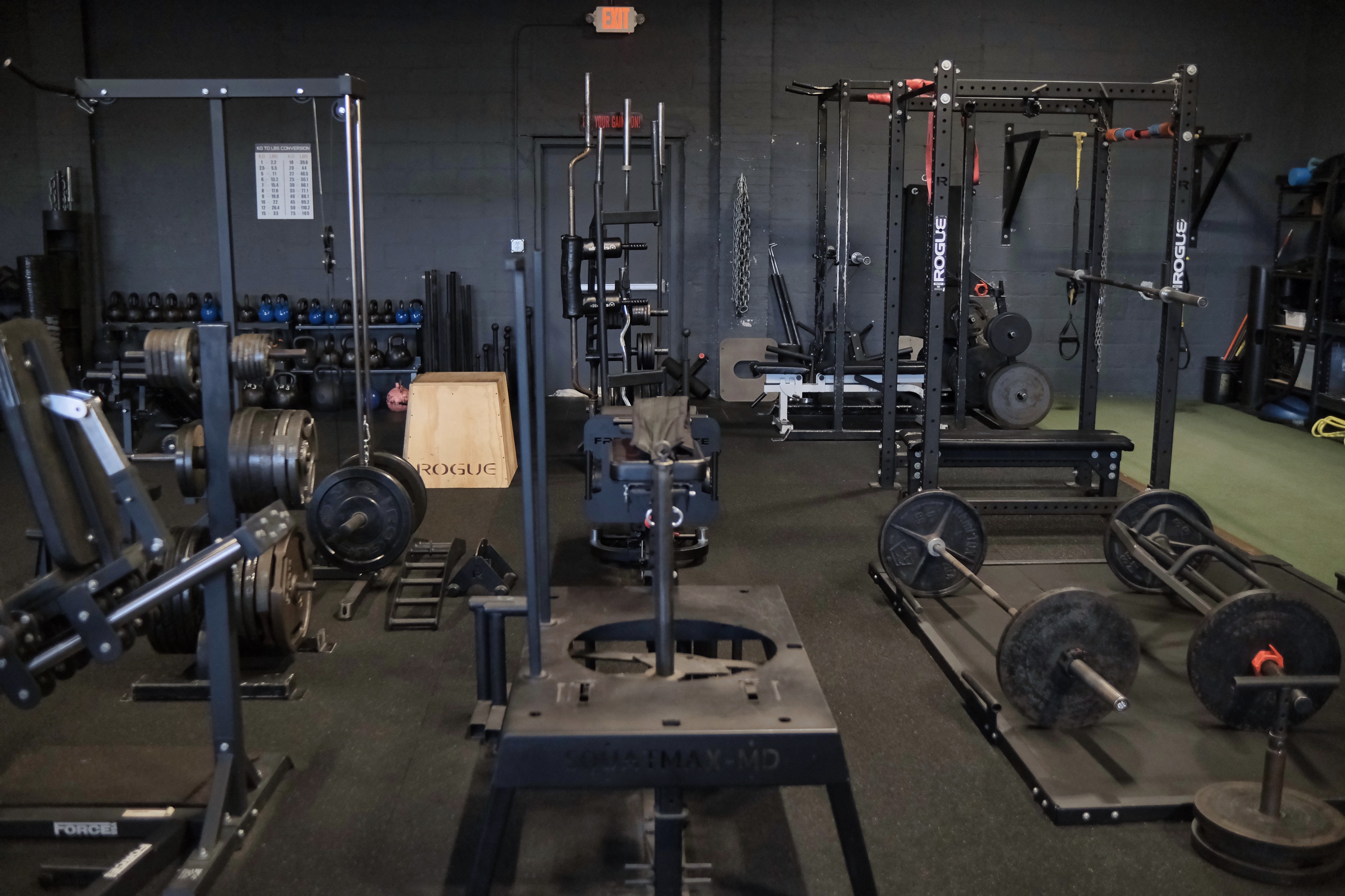 Wide view of facility with squat racks and equipment